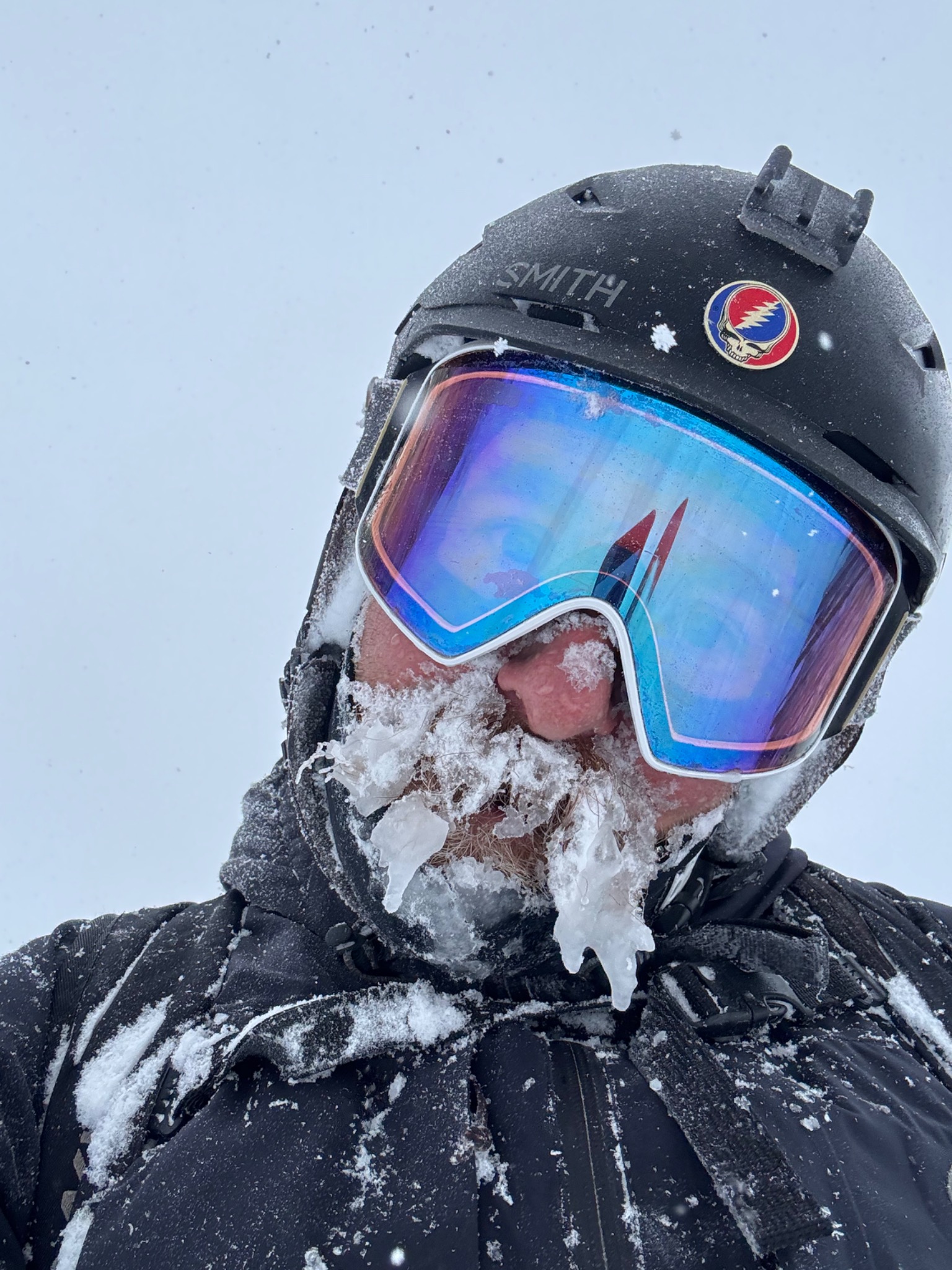 Matt Silver outdoors in ski goggles and a helmet, with a snow-covered beard